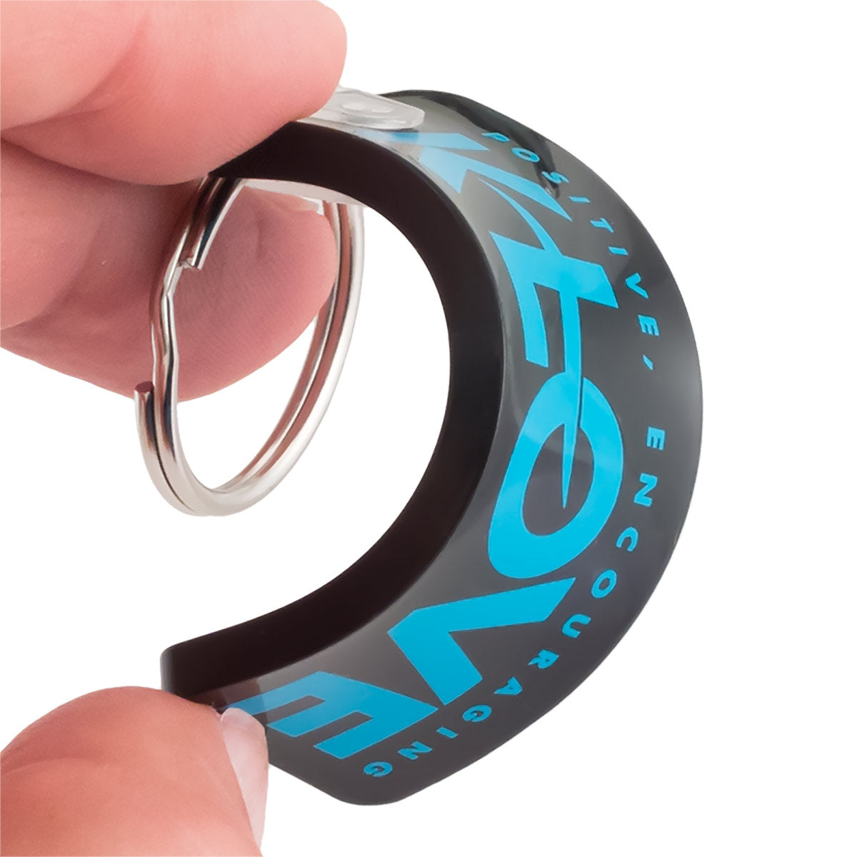 Flexible soft vinyl keychain material showing bend and durability